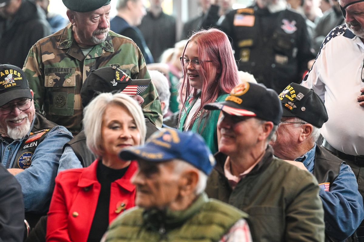 Brooklyn Mellott or Troop 5140 was one of the Girl Scouts circulating through the crowd handing out commemorative patches to service members gathered for Veterans Day ceremonies at the Numerical Veterans Arena Tuesday, Nov. 11, 2025 in Spokane, Washington. After the program, the scouts gave free Girl Scout cookies to the veterans as the crowd dispersed.  (Jesse Tinsley/THE SPOKESMAN-REVI)