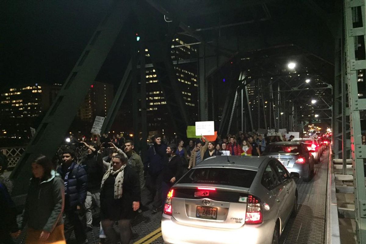 Protesters cross the Hawthorne Bridge in Portland, Ore., on the third day of protests over the results of the 2016 U.S. presidential election, Thursday, Nov. 10, 2016. President-elect Donald Trump fired back on social media after demonstrators in both red and blue states hit the streets for another round of protests, showing outrage over the Republican