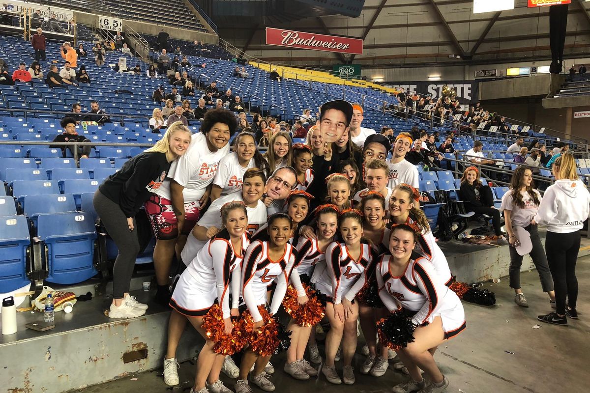 A spirited, if small, contingent of Lewis and Clark fans and cheerleaders gather for a photo at the Tigers boys semifinal game, which started a little after 9 p.m. on Friday, March 2, 2018 at the Tacoma Dome (Dave Nichols / The Spokesman-Review)