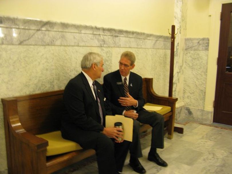 Sen. John Goedde, left, and Rep. Bob Nonini, right, the Senate and House education chairmen, confer before each speaks to legislative budget writers on Friday morning. (Betsy Russell)