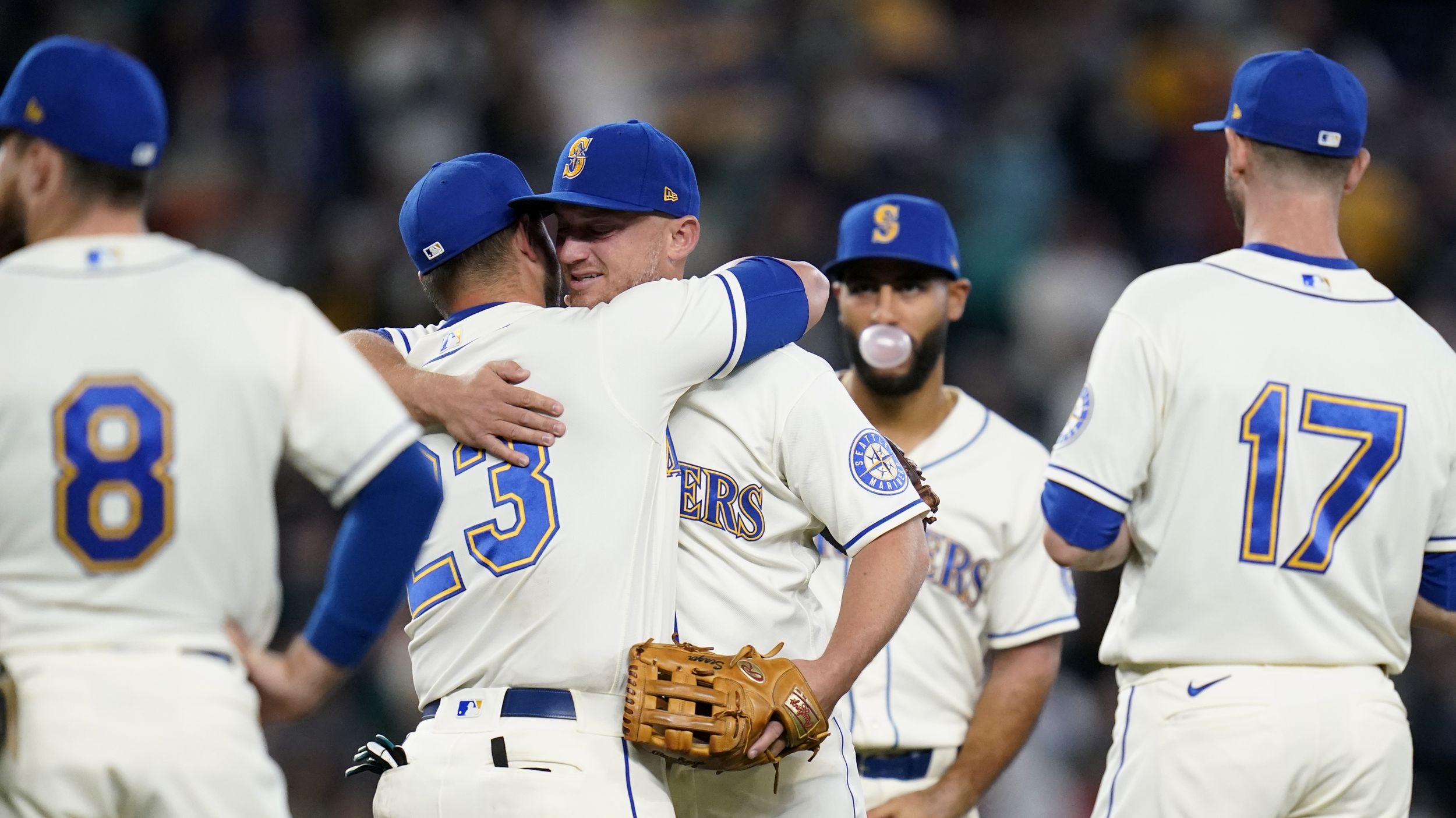 Seattle Mariners' Mitch Haniger, right, is greeted by Ty France