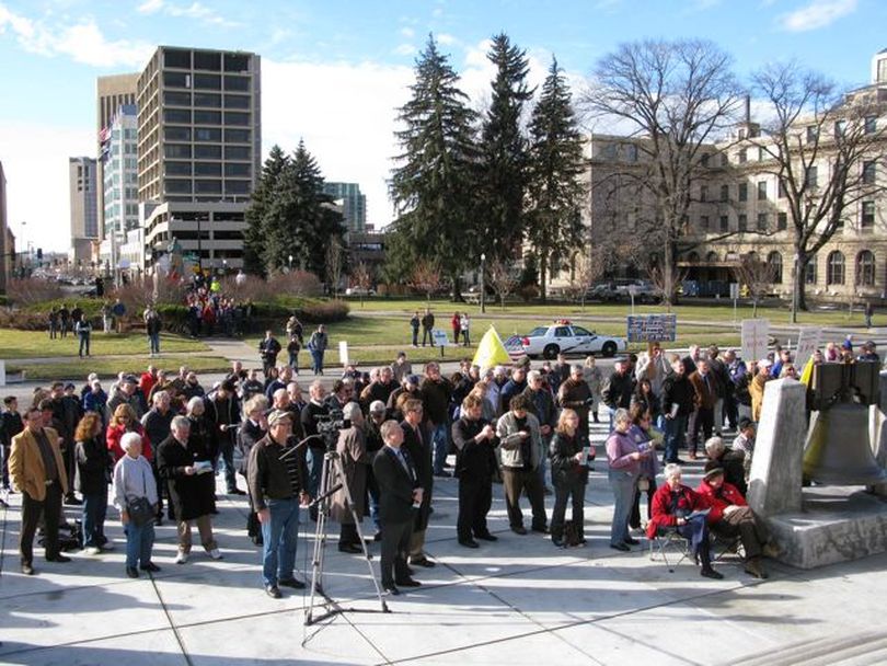 Participants in a tea party rally on the Idaho state capitol steps on Monday; across the street behind is a knot of protesters. (Betsy Russell)