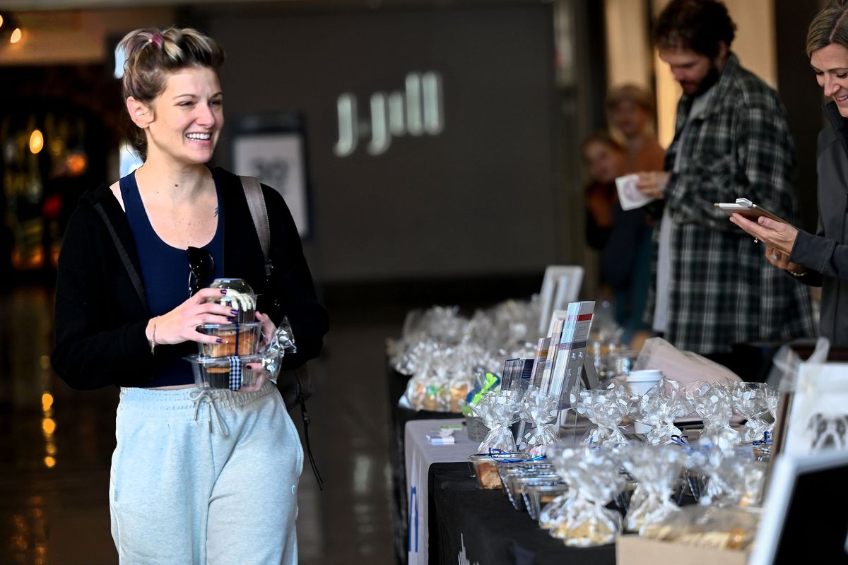 "I came to support NAMI (National Alliance on Mental Illness)," says Vanessa Johnson, left, after buying baked goods at the Depressed Cake Shop pop-up bakery at River Park Square in Spokane on Fri, Oct 6, 2023. (Kathy Plonka/The Spokesman-Review)
