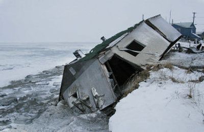 
Nathan Weyiouanna's abandoned house  in Shishmaref, Alaska,  still sits on the beach after sliding off during a storm in 2005. 
 (Associated Press / The Spokesman-Review)