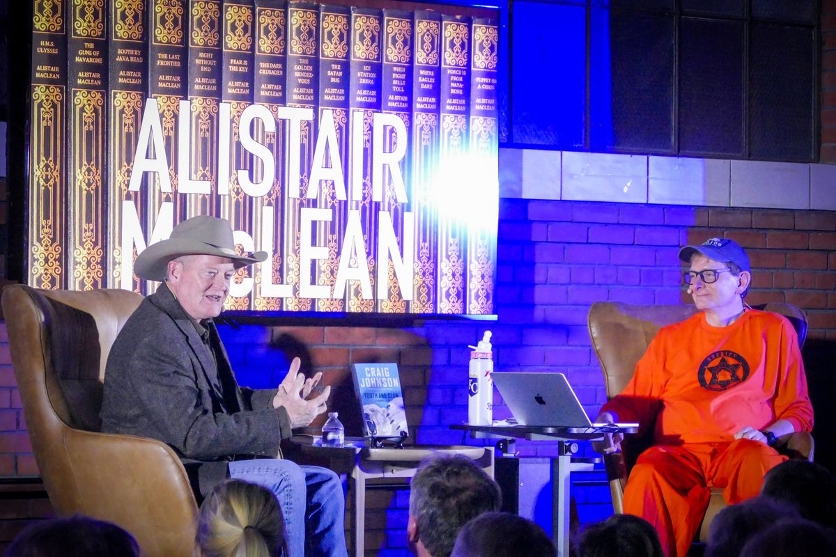 Author Craig Johnson, left, speaks with Spokesman-Review Editor Rob Curley about his writing and his love of author Alistair McLean at a gathering of the Northwest Passages Book Club Tuesday, Nov. 19, 2024 at the Steam Plant in Spokane, Washington. Johnson, famous for the western mystery series featuring Sheriff Walt Longmire, introduced his latest book, "Tooth and Claw." (Jesse Tinsley/THE SPOKESMAN-REVIEW)