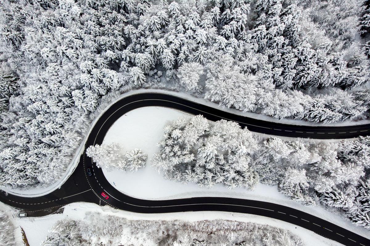 Cars drive on the road of the “Col du Mollendruz” among snow-covered trees in a forest after snowfall, in the Jura Mountains in Mont-la-Ville, Switzerland, on Sunday. (Laurent Gillieron)