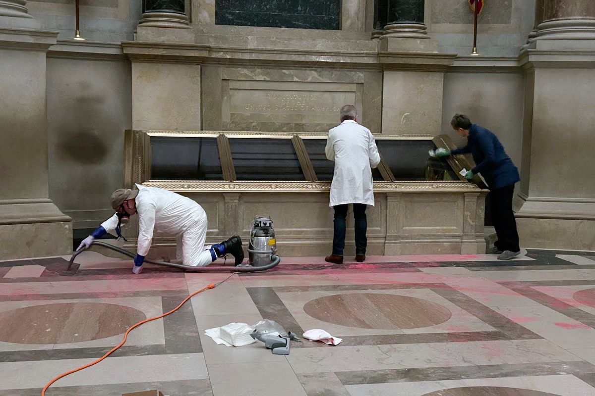 National Archives employees clean up after the vandalism on Feb. 14.  (Ellis Brachman/AP)