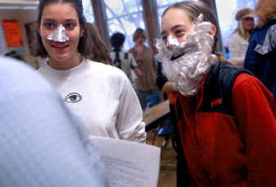 Lewis and Clark seniors Elise Klohe, left, and Lindsey Vercruyssen role-play the part of Tyco Brahe, an astronomer who thought the earth was the center of the universe, during an Enlightenment Salon in Susie Gerard's advanced placement European history class Thursday. Brahe had his nose cut off in a duel.
(Holly Pickett / The Spokesman-Review)