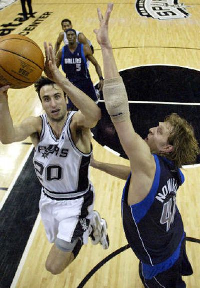 
San Antonio's Manu Ginobili shoots against Dallas' Dirk Nowitzki Tuesday. 
 (Associated Press / The Spokesman-Review)