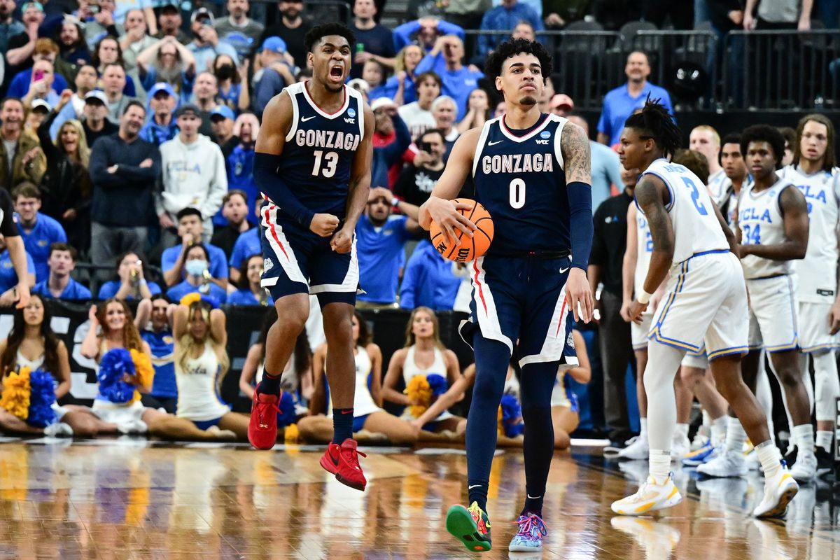 Gonzaga Bulldogs guard Julian Strawther (0) struts after hitting a game-winning shot against the UCLA Bruins as guard Malachi Smith (13) erupts in celebration during the second half of an NCAA Tournament Sweet Sixteen basketball game on Thursday, March 23, 2023, at T-Mobile Arena in Las Vegas, Nev. Gonzaga won the game 79-76.  (Tyler Tjomsland/The Spokesman-Review)