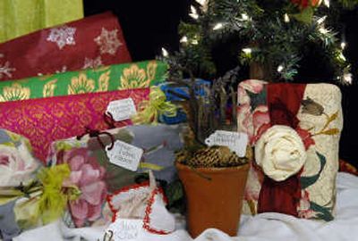 
Gloria Waggoner of the Rosa Gallica uses vintage fabric and ribbons, Fair Trade handmade papers and recycled packing for wrapping gifts.
 (Dan Pelle / The Spokesman-Review)