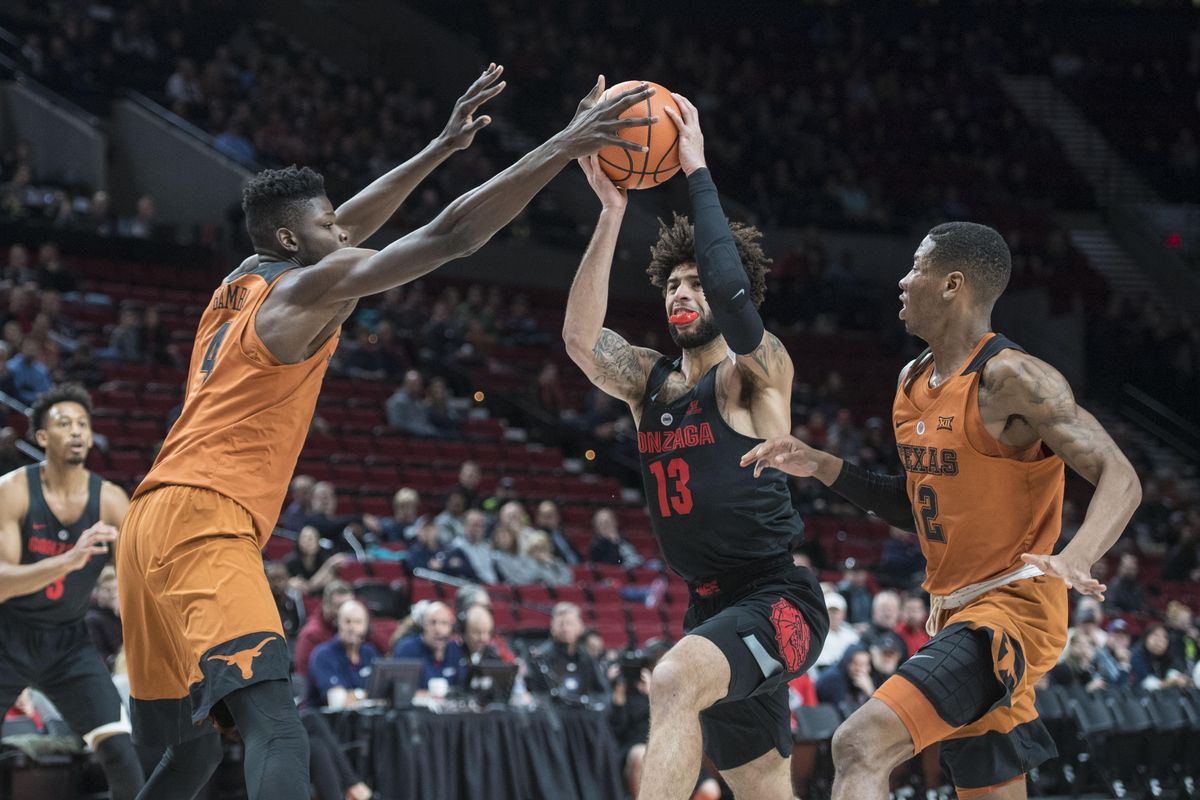 Gonzaga guard Josh Perkins drives on Texas forward Mohamed Bamba (4) and guard Kervin Roach II, Sunday, Nov. 26, 2017, in the Moda Center. (Dan Pelle / The Spokesman-Review)