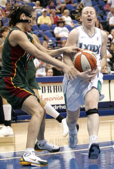 
Lynx's  Kristi Harrower, right, loses  the ball as she is fouled by Storm's  Sue Bird.  
 (Associated Press / The Spokesman-Review)