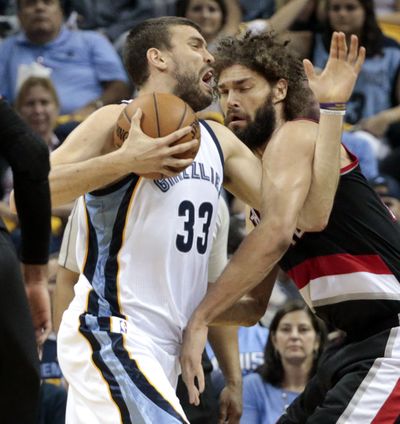 Portland’s Robin Lopez, right, tries to strong-arm Marc Gasol. (Associated Press)