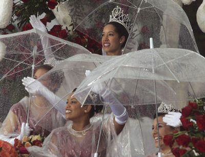 
Rose Queen Camille Clark, top, rides with her court as the Rose Parade makes its way through the streets of Pasadena, Calif., Monday morning. It poured during the parade, which has not happened in over 50 years. 
 (Anne Cusack/Los Angeles Times / The Spokesman-Review)