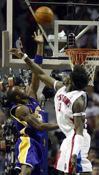 
Detroit's Ben Wallace, right, tries to block a shot by Los Angeles' Kobe Bryant during first-half action on Sunday. 
 (Associated Press / The Spokesman-Review)