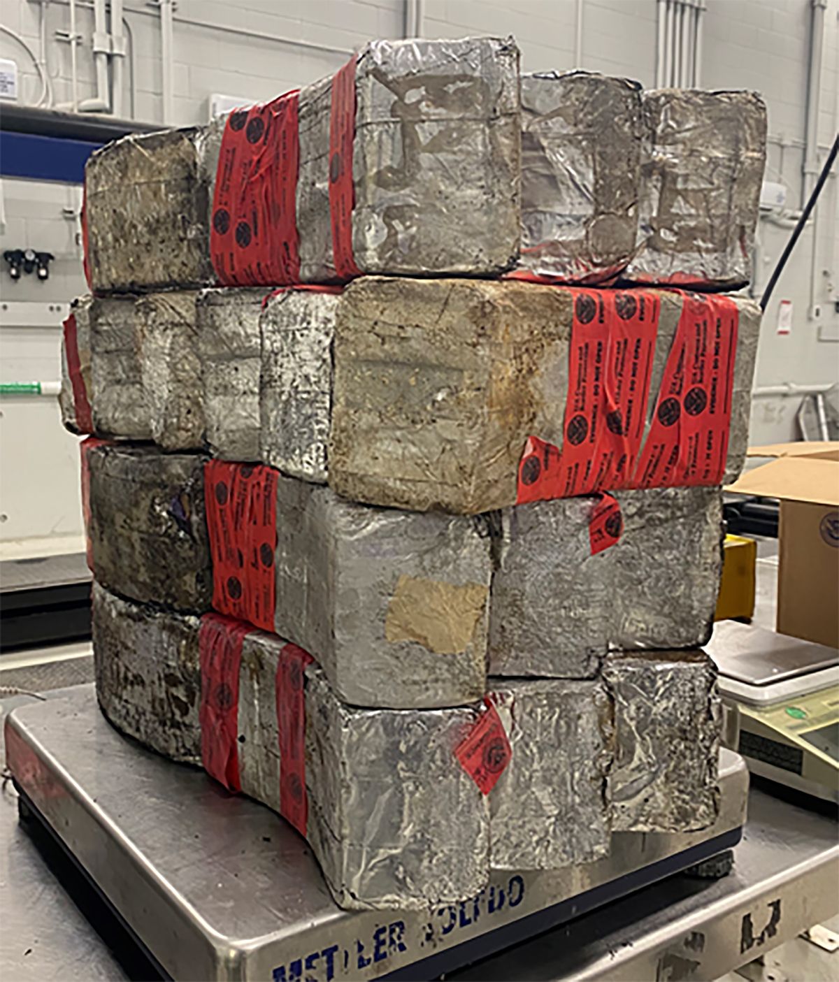 This undated photo provided by the U.S. Customs and Border Protection shows seized drug bundles containing 132 pounds of methamphetamine on display from Feb. 25, 2021, at the Laredo port of entry. The drugs were concealed in a vehicle driven by 23-year-old U.S. citizen traveling from Mexico. Since the start of the coronavirus pandemic, an increasing number of U.S. citizens have been apprehended while they have tried to smuggle illegal drugs at the Southwest border.  (HOGP)
