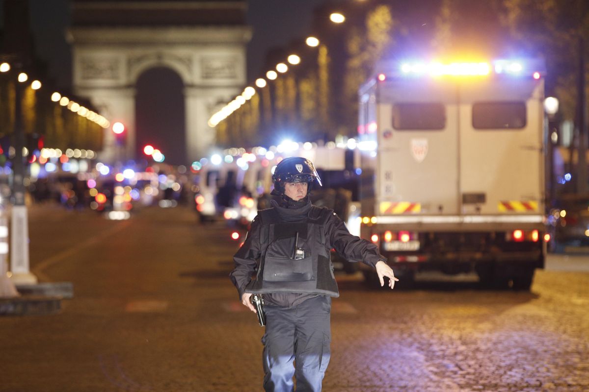 A police officer stands guard after a fatal shooting in which a police officer was killed along with an attacker on the Champs Elysees in Paris on Thursday, April 20, 2017. (Thibault Camus / Associated Press)