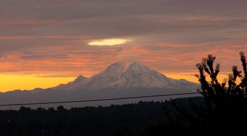 A hole in the clouds offers the gods a spotlight view of Mount Rainier. (Rick Rocheleau)