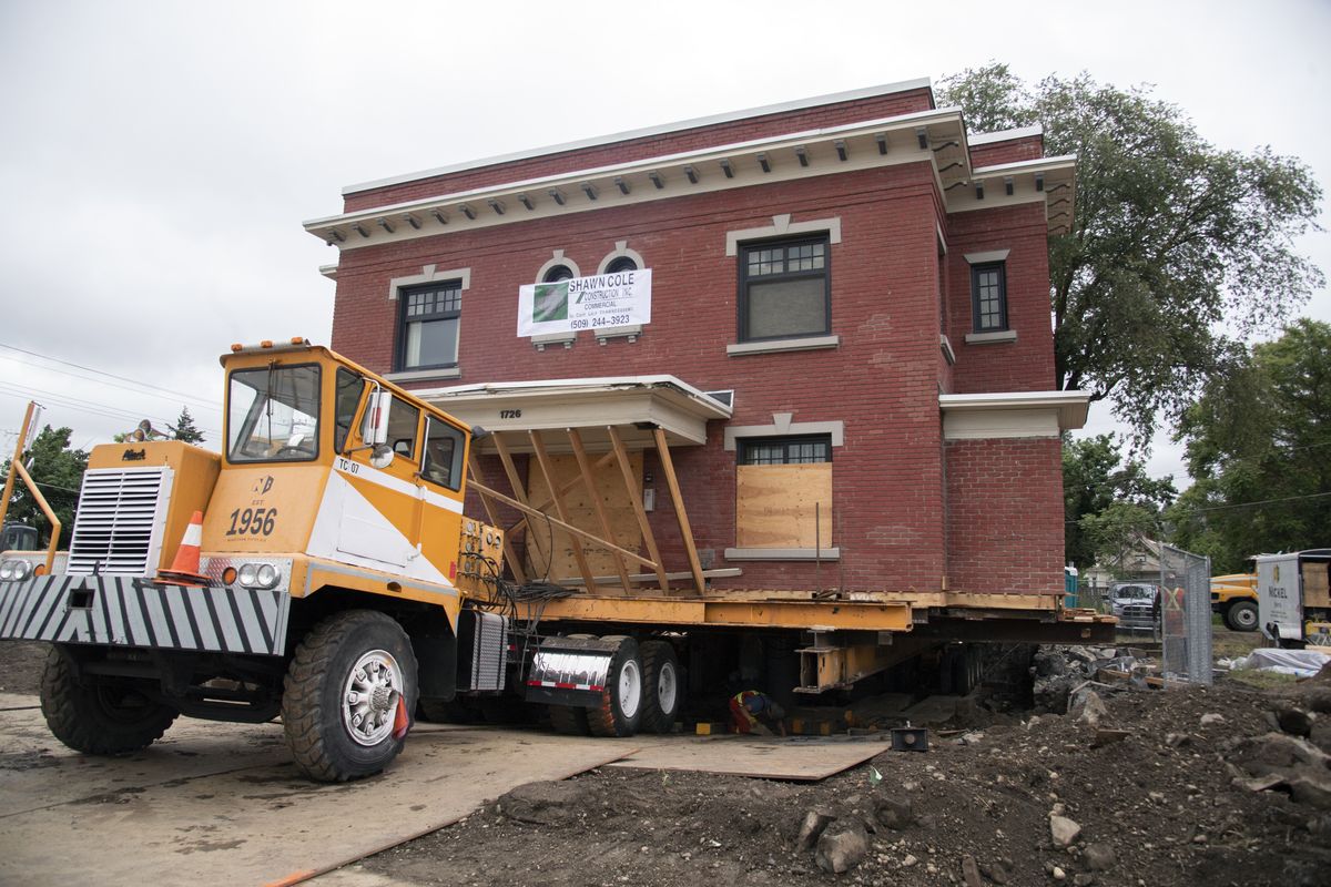 The two-story Rose Apartments building inches slowly off its foundation on Third Avenue and heads to Fourth Avenue where the historic building will rest on a new foundation in East Central Spokane. It took most of the day Tuesday, June 16, 2020 to move the massive building.  (JESSE TINSLEY)