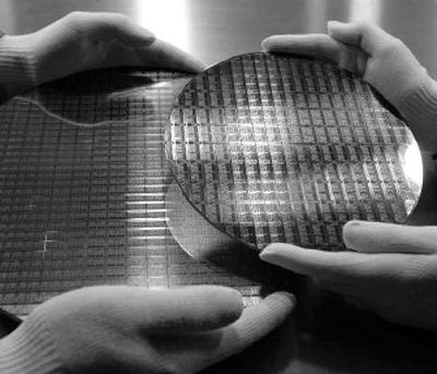 
The dummies of a 200mm wafer, right, and a 300mm wafer, left, are seen at Advanced Micro Devices Inc. in Dresden, Germany, on Thursday. AMD snared a huge slice of the microprocessor market from archrival Intel Corp., only to find that it might have paid too high a price for its victories. 
 (Associated Press / The Spokesman-Review)