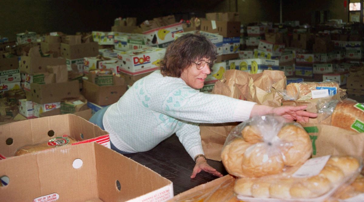 1995: Deloris Walker organizes paper bags filled with donated food for the Thanksgiving food basket distribution run by the Salvation Army in Spokane. Donated food was collected by the Boy Scouts, and many turkeys were donated by the Spokane Food Bank. Other items which make up the Thanksgiving feast were donated by shoppers at local grocery stores.  (Liz Kishimoto/THE SPOKESMAN-REVIEW)