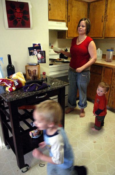 
Tara Dennis makes Ramen noodles for lunch for her sons Payton Butcher, 3, left, and Gavin Butcher, 1, right, in her Missoula apartment. 
 (Associated Press / The Spokesman-Review)