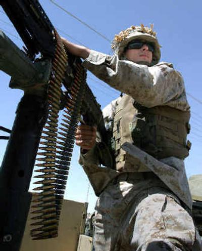 
U.S. Marine Lcpl. Brandon Johnson, of Pleasant Grove, Utah, from the 1st Battalion, 5th Marine Regiment, patrols in a Humvee in Kandari, Iraq, earlier this month.U.S. Marine Lcpl. Brandon Johnson, of Pleasant Grove, Utah, from the 1st Battalion, 5th Marine Regiment, patrols in a Humvee in Kandari, Iraq, earlier this month.
 (Associated Press photosAssociated Press photos / The Spokesman-Review)