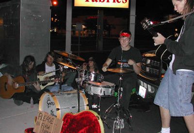 
Lysdexic band members, from left, Neil Mendenhall, Jeremy Vanorman, Travis Tveit and Joel Drexel play on the corner of Sprague Avenue and Sullivan Road.
 (JENNIFER LARUE / The Spokesman-Review)