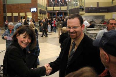 
Interim Superintendent Nancy Stowell  shakes hands last week with Chuck Bisordi at Rogers High School. 
 (Rajah Bose / The Spokesman-Review)