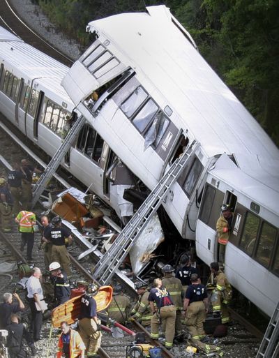 ORG XMIT: DCPM301 District of Columbia Fire and Emergency workers at the site of a rush-hour collision between two Metro transit trains in northeast Washington, D.C. Monday, June 22, 2009. (AP Photo/Pablo Martinez Monsivais) (Pablo Monsivais / The Spokesman-Review)