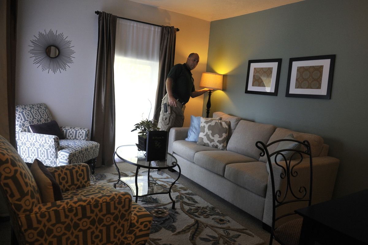 Innkeeper John Hough turns on a light in a redesigned room at the Roosevelt Inn in Coeur d’Alene. Hough’s bed-and-breakfast was subjected to a visit by TV chef Gordon Ramsay, who analyzed and critiqued the operation from top to bottom. The “Hotel Hell” team redecorated the room, changing it from a bedroom in a two-room suite to a sitting room. (Jesse Tinsley)