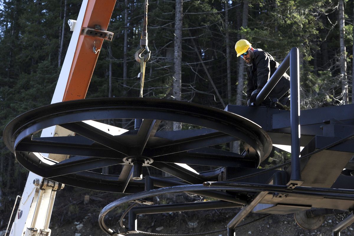 Stefan Jones watches as his crew carefully lifts a large pulley, called a “bull wheel,” into place at Lookout Pass Ski Area on Thursday. Crews at ski areas are busy with maintenance and safety checks on their equipment prior to season openings, which are usually around Thanksgiving. (Jesse Tinsley)