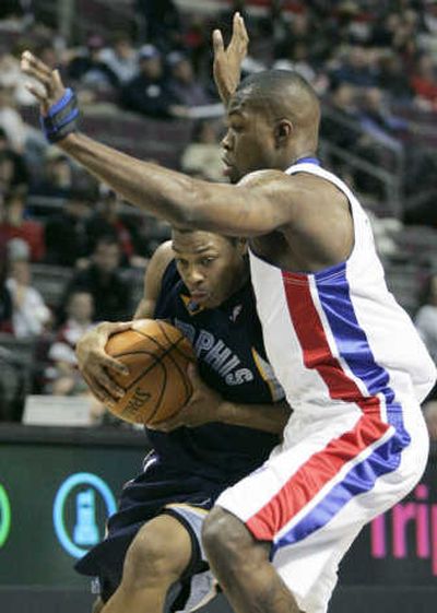 
Detroit rookie and former Eastern Washington standout Rodney Stuckey defends against Memphis guard Kyle Lowry in Stuckey's NBA regular-season debut Friday. 
 (Associated Press photos / The Spokesman-Review)