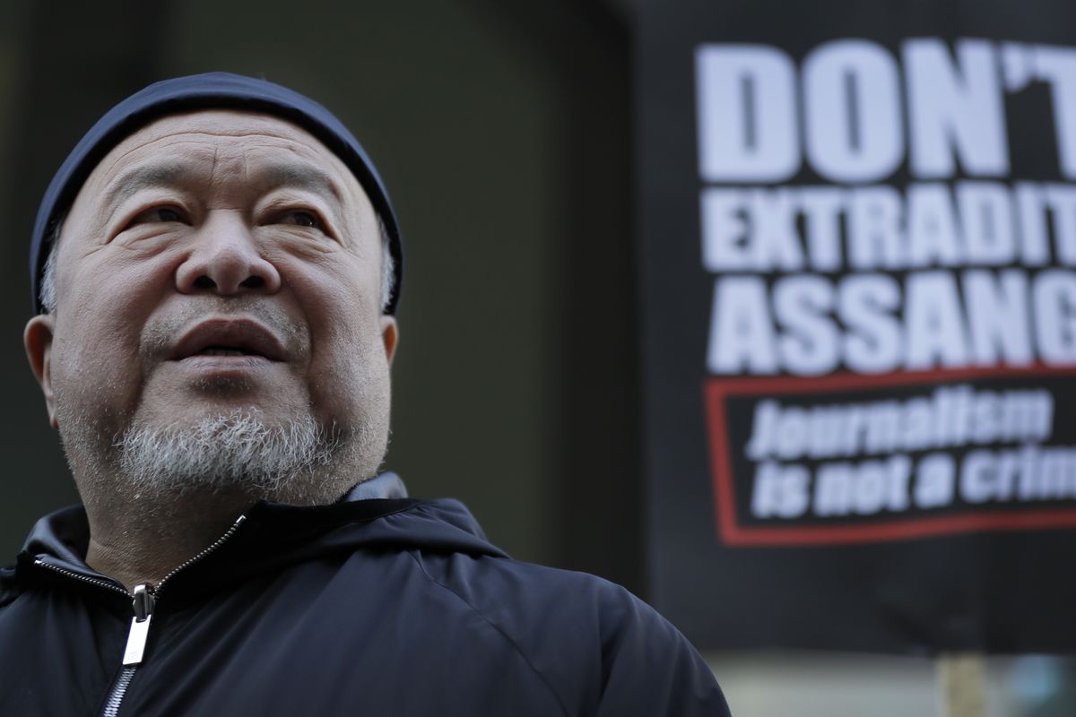 Chinese contemporary artist and activist Ai Weiwei stands with protesters Monday outside the Old Bailey in London.  (Kirsty Wigglesworth)