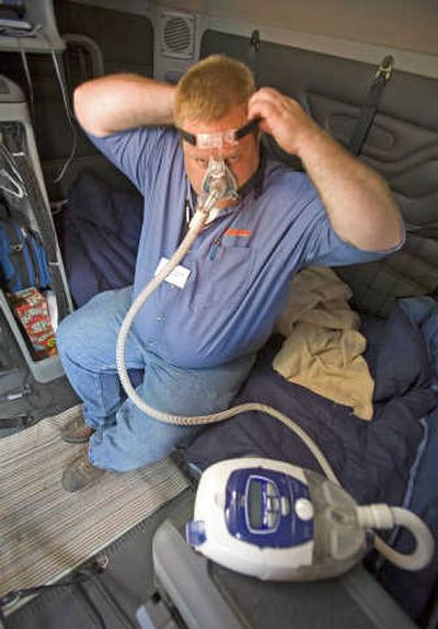 
Truck driver Charlie Resch shows off a machine he keeps in the cab of his truck to help him deal with his sleep apnea, a disorder that interferes with breathing during sleep and can leave the sufferer groggy and exhausted. Associated Press
 (Associated Press / The Spokesman-Review)