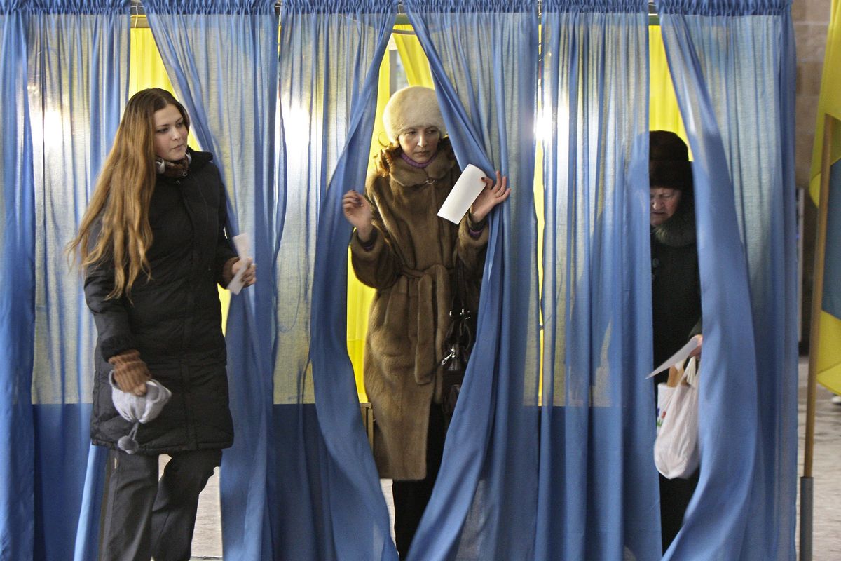 Ukrainian women leave the booths at a polling station during presidential elections in Dnipropetrovsk, Ukraine, on Sunday.  (Associated Press)