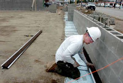 
Carpenter Shad Bowen works on the building for the new AutoZone store on Government Way, just north of Appleway in Coeur d'Alene, on Wednesday. 
 (Jesse Tinsley / The Spokesman-Review)