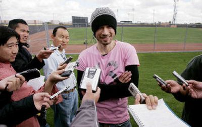 
Japanese media members interview Seattle's Ichiro Suzuki on Tuesday after his first workout with the Mariners in Peoria, Ariz. 
 (Associated Press / The Spokesman-Review)