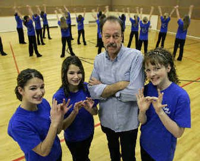 
Dan Robertson stands with students, from left, Kris and Keri Knudsen and Stephanie Wright  in Preston. The girls performed a Happy Hands sign language routine in 