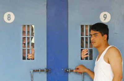 
Prisoners are seen in their cells as another stands outside in the Hadarim prison, north of Tel Aviv, on Sunday. About 1,600 Palestinian prisoners began a hunger strike Sunday to protest conditions in Israeli jails, but Israel's Public Security Minister has said they can 