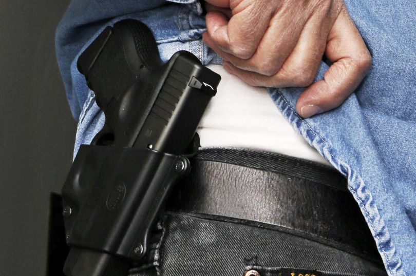 In this Feb. 27, 2013, file photo Hank Johnson displays his handgun. (Al Behrman / AP)