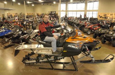 
Eric Holt, owner of Allsport, sits atop a Polaris 600 RMK snowmobile at his new shop in the Spokane Valley. 