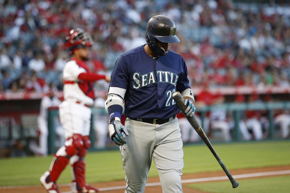 Seattle’s Robinson Cano walks off the field after striking out during the first inning Saturday against the Los Angeles Angels in Anaheim, Calif. (Jae C. Hong / AP)