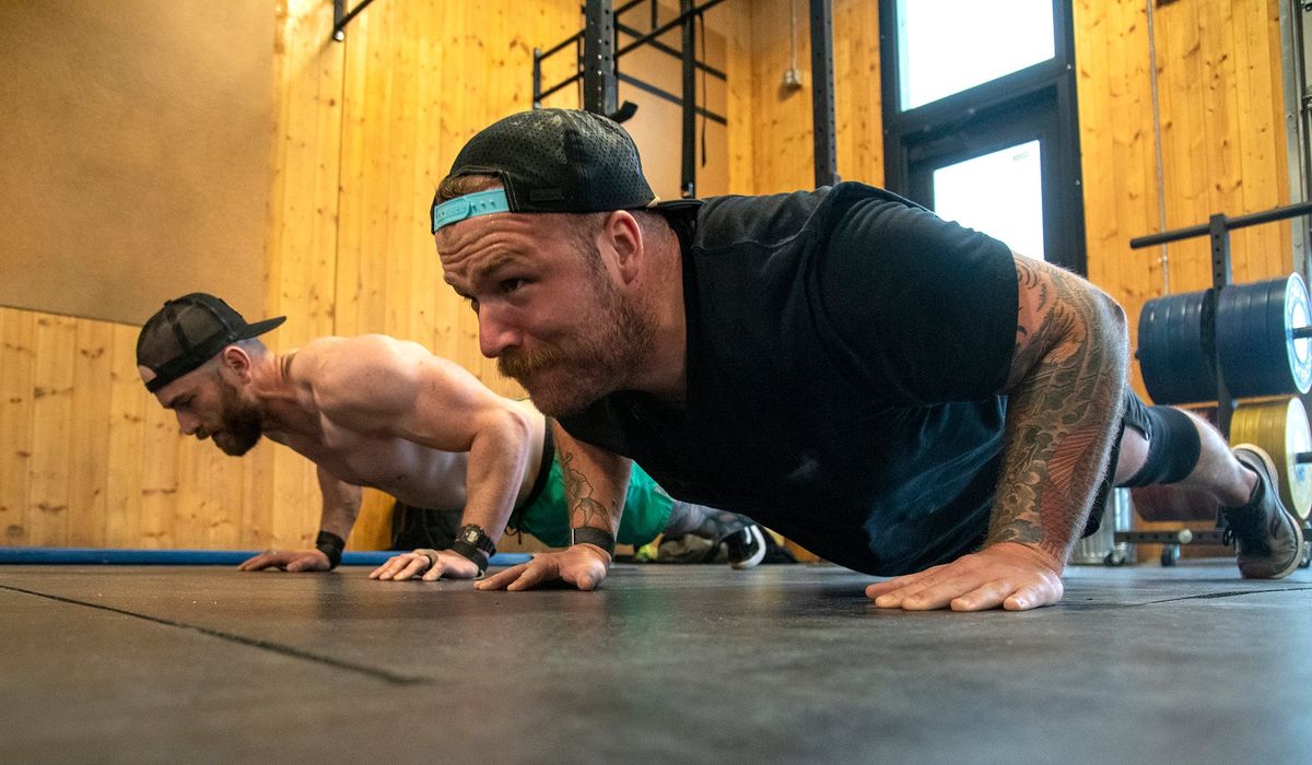 David FauntLeRoy, left, and workout partner Dan Hicks, right, do push-ups at Duratus Strength and Conditioning Tuesday, May 24, 2022 in Spokane, Washington.  (Jesse Tinsley/The Spokesman-Review)