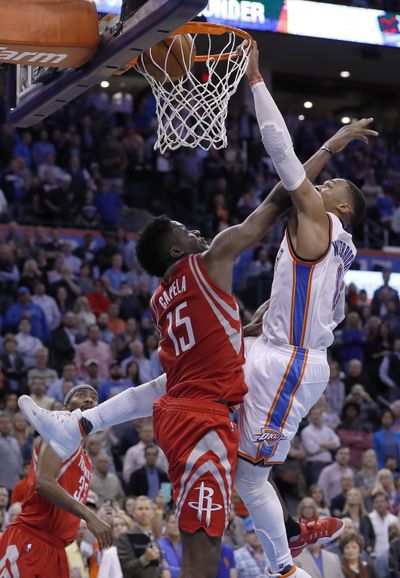 Oklahoma City Thunder guard Russell Westbrook dunks over Houston Rockets center Clint Capela during the final seconds of an NBA basketball game in Oklahoma City, Wednesday, Nov. 16, 2016. (Alonzo Adams / Associated Press)