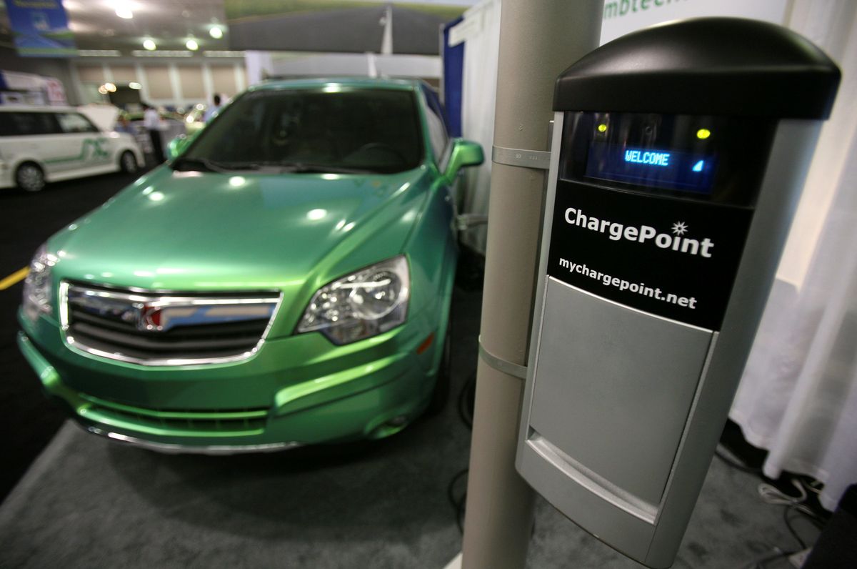 A Saturn Vue plug-in hybrid vehicle is shown with a Smartlet charging station at the Coulomb Technologies exhibit at the Plug-In 2008 conference on plug-in hybrid vehicles in San Jose, Calif.Associated Press photos (Associated Press photos / The Spokesman-Review)