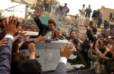 
Afghan presidential candidate Mohammed Mohaqeq greets a throng of supporters a day after the country's first-ever direct presidential elections in Kabul, Afghanistan, on Sunday. 
 (Associated Press / The Spokesman-Review)