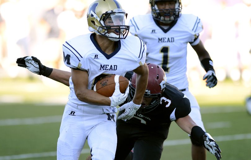 Mead's  running back Daniel Munoz picks off an NC pass and runs it in for a touchdown during the first half of their GSL high Friday, Sept.12, 2013, at Joe Albi Stadium. The score at this point in the game is 21-0 Mead. (Colin Mulvany / The Spokesman-Review)
