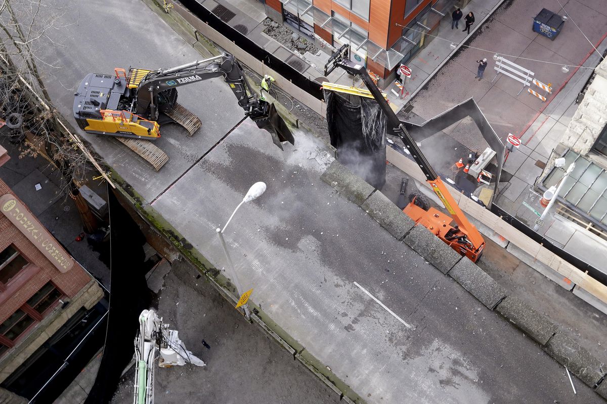 Crews begin work dismantling the Alaskan Way Viaduct, beginning on the southbound Columbia Street on-ramp, Friday, Feb. 15, 2019, in Seattle. The 2.2-mile  major thoroughfare built in 1953 along the downtown waterfront was shut down in January and has been replaced by a new tunnel. (Elaine Thompson / Associated Press)